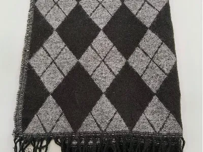 Gefalteter Strickschal in Anthrazit und Grau mit klassischem Argyle-Rautenmuster und schwarzen Tassel-Fransen auf weißem Untergrund