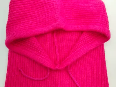 Pink gerippter Strick-Balaclava mit Schnürbändern, flach auf weißem Untergrund liegend