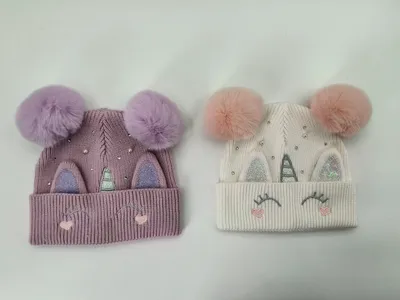Zwei Einhorn-Beanies für Kinder in Lavendel und Cremeweiß mit flauschigen Doppel-Pompons, Glitzer-Hörnern, bestickten Wimpern und funkelnden Strasssteinen