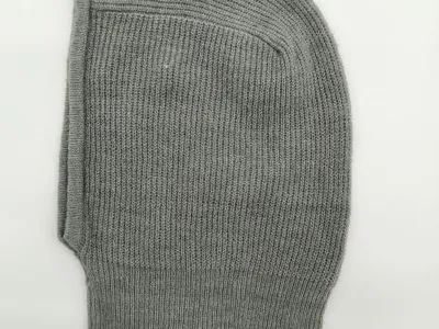 Draufsicht einer grauen Rippstrick-Balaclava mit ovaler Gesichtsöffnung auf weißem Untergrund