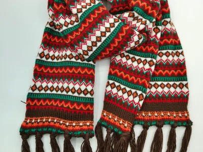 Bunter gestrickter Fair-Isle Schal mit geometrischen Mustern in Rot, Grün, Orange, Weiß und Braun sowie dunkelbraunen Fransenden