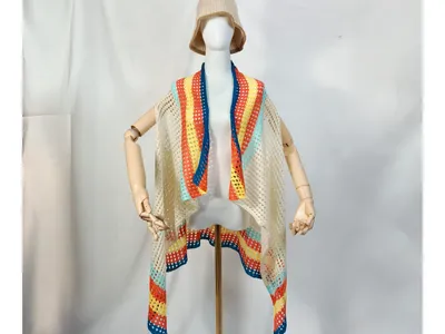 Cremefarbene Häkelweste im offenen Kimono-Stil mit bunten Streifen in Blau, Orange, Gelb und Mint auf Schaufensterpuppe mit Bucket Hat