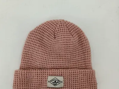 Strickmütze in Altrosa mit Waffelstruktur, umgeschlagenem Bund und gewebtem Etikett-Patch, Draufsicht auf weißem Untergrund