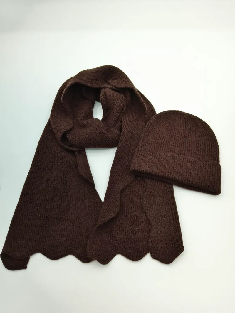 Schokoladenbrauner Rippenstrick-Schal mit Bogensaum und passende Beanie-Mütze auf weißem Untergrund
