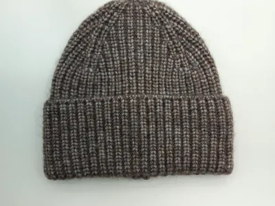 Taupe-braune Marl-Strickmütze aus Wollmischung mit Rippenmuster und gefaltetem Krempenrand, Draufsicht auf weißem Hintergrund