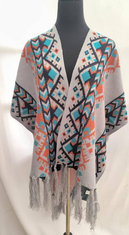Offener Strickmantel im Boho-Stil mit geometrischem Muster in Grautönen, Petrol und Orange, mit Fransenabschluss an Saum und Ärmeln