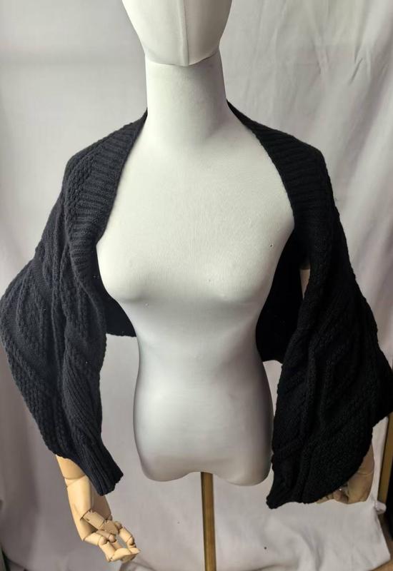 Schwarzer grob gestrickter Bolero-Shrug mit breiten Fledermausärmeln auf einer Schneiderpuppe