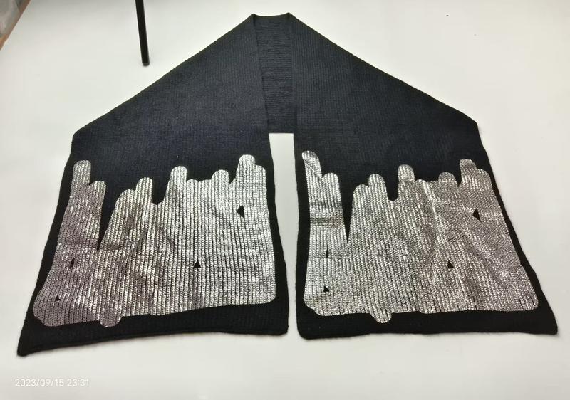 Schwarzer gestrickter Schal mit aufgedruckter silberner Stadtsilhouette an beiden Enden auf weißer Fläche
