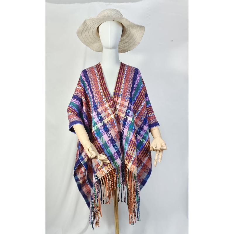 Schaufensterpuppe mit mehrfarbigem geometrisch gewebten Überwurf-Poncho und Fransensaum sowie Naturstrohhut